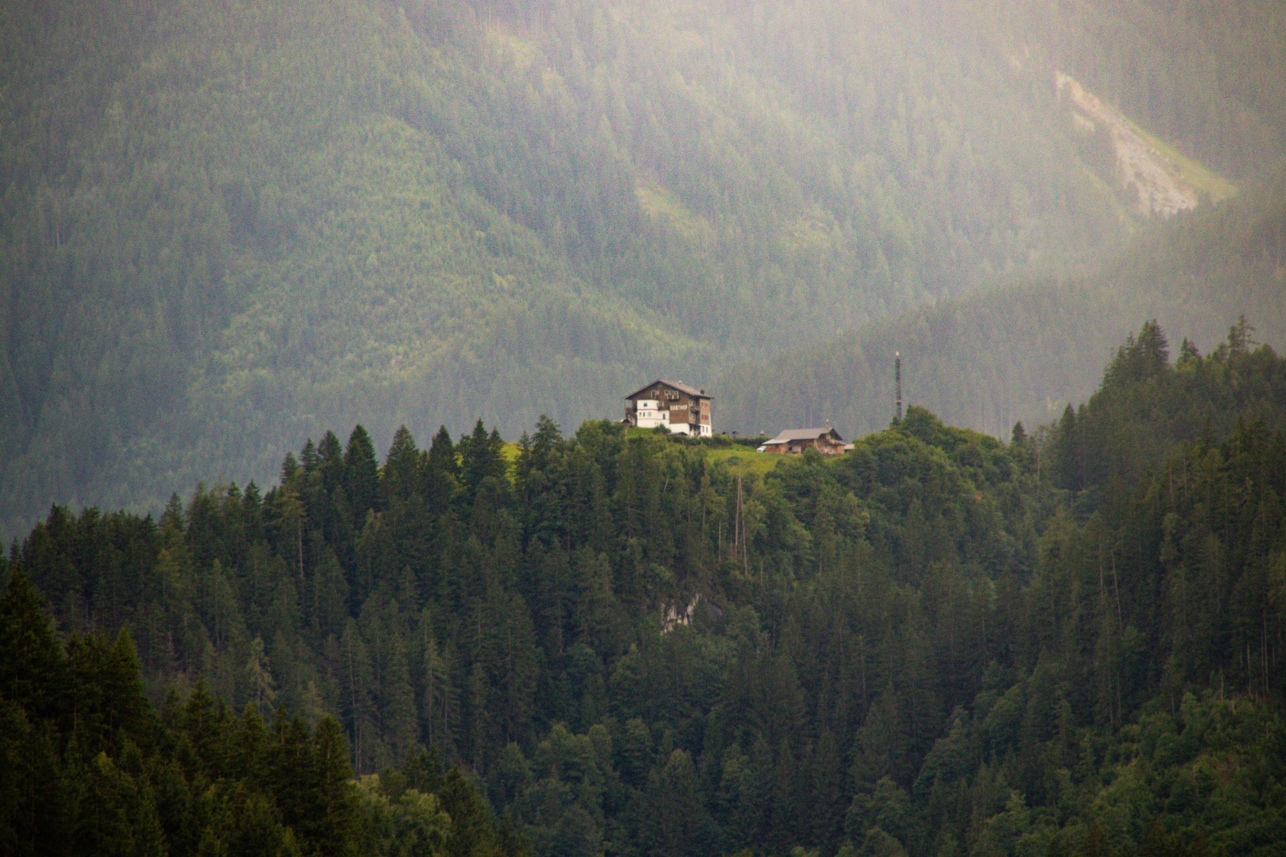 Mountain chalet perched on a forested hillside, a serene and isolated retreat